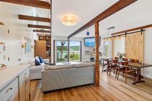 a kitchen and living room with a couch and a table at Steps to Beach: Martha's Vineyard Private Retreat! in Vineyard Haven