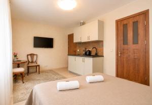 a room with a bed with two towels on it at KUBU Loft in Klaipėda