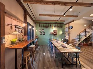 a dining room with long tables and chairs at 山沐三薰 2館 可包棟含蔬食早餐 in Shangwu