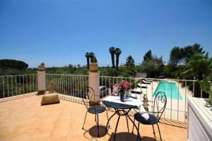 a patio with a table and chairs next to a pool at Hotel Residence Noto Marina Relais in Calabernardo