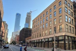 a large brick building on a city street with buildings at Duane Street Hotel Tribeca, Belvilla District 6 Formerly Sonder in New York