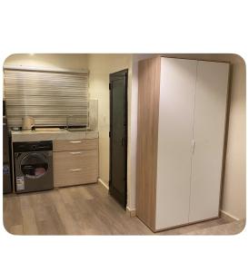 a kitchen with a stove and a washer and dryer at Dakar center studio house in Dakar