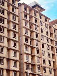 a large brick building with many windows at Mazar New palaza 