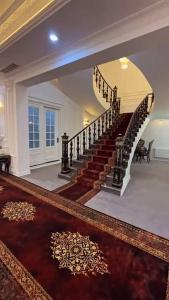 a spiral staircase in a house with a rug at Mazar New palaza 