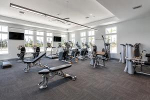 a gym with several treadmills and cardio machines at The Palm LK Private Beach Club 100"TV in Pensacola