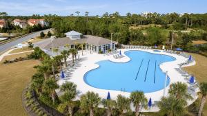 an overhead view of a swimming pool at a resort at The Palm LK Private Beach Club 100"TV in Pensacola