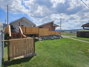 a house with a fence in a yard at GlampCamp in Big Arm