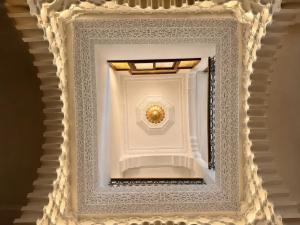 a stairway with a white ceiling with a gold ball at Hiking Nomads Guesthouse in Tamellalt