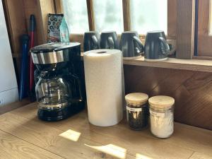 a kitchen counter with a coffee maker and other appliances at GlampCamp in Big Arm