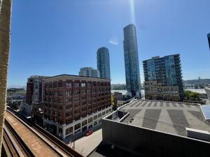a view of a city with tall buildings and train tracks at Arundel Mansions Hotel in New Westminster