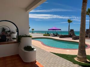 a resort with a swimming pool and the ocean at Paradise Villa #5 in Puerto Peñasco