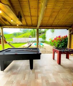 a pool table in the middle of a patio at Imperatriz Cabanas (Chalé 2 com piscina e hidro) in Santo Amaro da Imperatriz