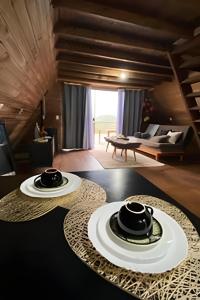 a room with a table with two plates on it at Imperatriz Cabanas (Chalé 2 com piscina e hidro) in Santo Amaro da Imperatriz