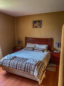 a bedroom with a bed with two night stands and two lamps at B&B Cotacachi Hosteria Oro Azul in Cotacachi +9 photos