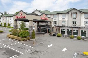 an empty parking lot in front of a hotel at Ramada by Wyndham Surrey/Langley in Langley