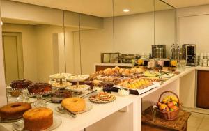a buffet with many different types of food on a table at Villa di Cavi Hotel in Gramado