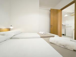 a bedroom with two beds and a mirror at Le casette Punta Pizzo in Gallipoli