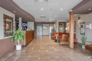 a lobby of a hospital with chairs and a waiting room at Ramada by Wyndham Surrey/Langley in Langley +23 photos