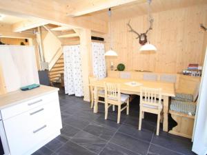 a dining room with a wooden table and chairs at Wolkenheim in Hohentauern
