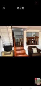 a living room with stairs and a living room with a couch at Jenny's accomodation in Baguio