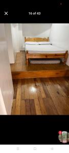 a bed sitting on top of a wooden floor at Jenny's accomodation in Baguio