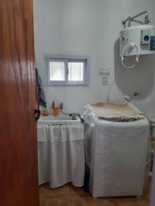 a kitchen with a sink and a tub and a table at Cabaña-Villa General Savio in Sánchez