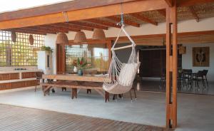 a hammock hanging from a porch of a house at Casa Orybá in Prado