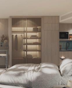 a bedroom with a large bed and a closet at U North Coast in Sidi Kirayr