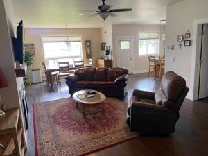 a living room with couches and a table and a dining room at Hometown Place in Missoula