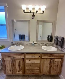 a bathroom with two sinks and two mirrors at Hometown Place in Missoula +21 photos