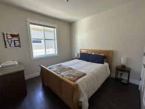 a bedroom with a large bed with a window at Hometown Place in Missoula