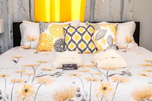 a bed with orange and yellow pillows on it at The Grand View Beachfront Villa - Sleeps up 10 in Nassau