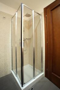 a shower with a glass door in a bathroom at Hotel San Rocco in Muggia