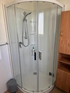 a shower with a glass enclosure in a bathroom at Bristol Motel - HOUSE in Upper Hutt