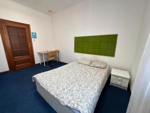 a small bedroom with a bed and a desk at StayPoz-Stary Rynek in Poznań