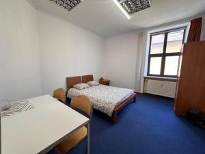 a room with two beds and a table in it at StayPoz-Stary Rynek in Poznań +40 photos