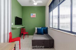 a room with a bed and a chair and a tv at Studio the city center 300m Pelourinho HAI0203 in Salvador