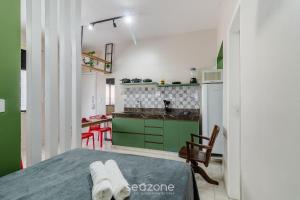 a small kitchen with a green and white kitchen at Studio the city center 300m Pelourinho HAI0203 in Salvador