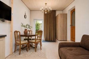 a living room with a table and chairs and a couch at KUBU Loft in Klaipėda