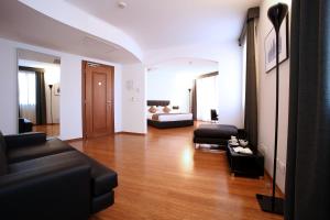 a living room with a couch and a bed at Hotel San Rocco in Muggia