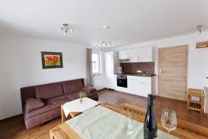 a living room with a couch and a table at Pension Christina in Vaihingen an der Enz