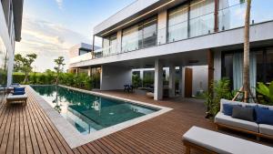 an exterior view of a house with a swimming pool at UNIT Nuanu Village in Canggu
