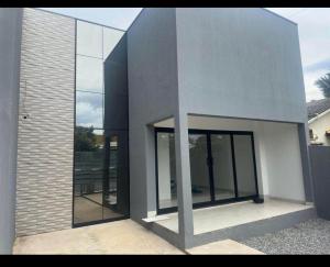 a building with glass doors on the side of it at Residential Florence Nightingale in Sorriso