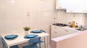 a kitchen with a table with blue plates on it at Affittacamere San Nicola in Montella