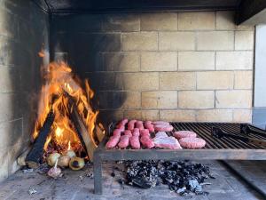 a brick oven with a bunch of food on it at Casa de Campo Urpichay in Ricardo Palma