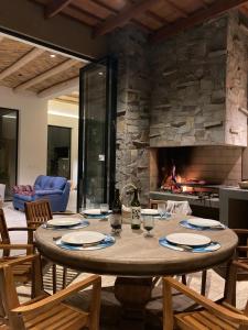 a dining room with a table and a fireplace at Casa de Campo Urpichay in Ricardo Palma