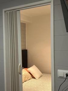 a door leading into a bedroom with a bed at La Casina del Puerto in Luarca +17 photos
