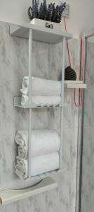 a white towel rack in a bathroom with towels at Affittacamere San Nicola in Montella +17 photos