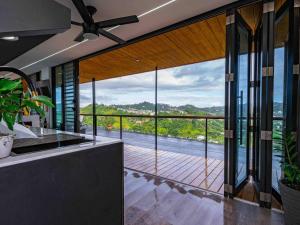 a kitchen with a large window with a view at Vibra Barranquitashot pool in Barrancas