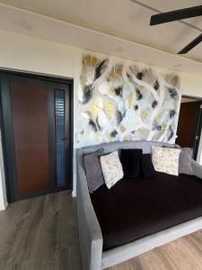 a bedroom with a large bed with a mural on the wall at Vibra Barranquitashot pool in Barrancas +28 photos